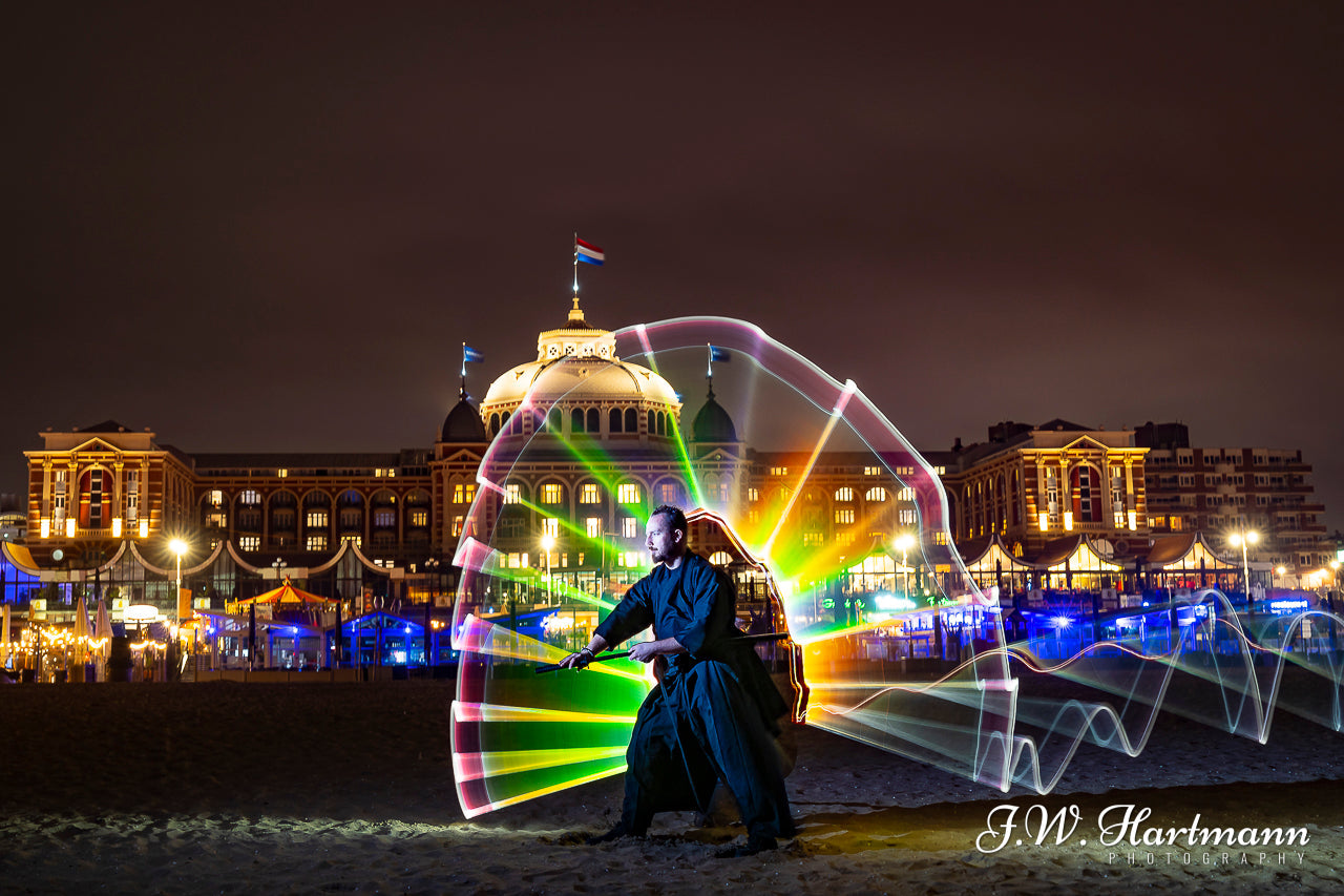 light painting on the beach with model, warm light graffiti