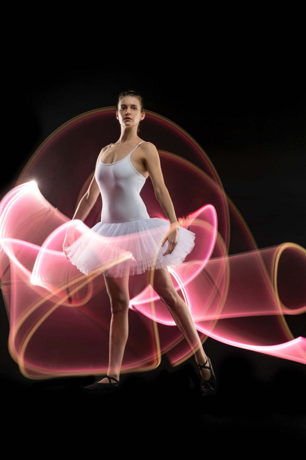 pretty pink dancer in motion photography with long exposure camera