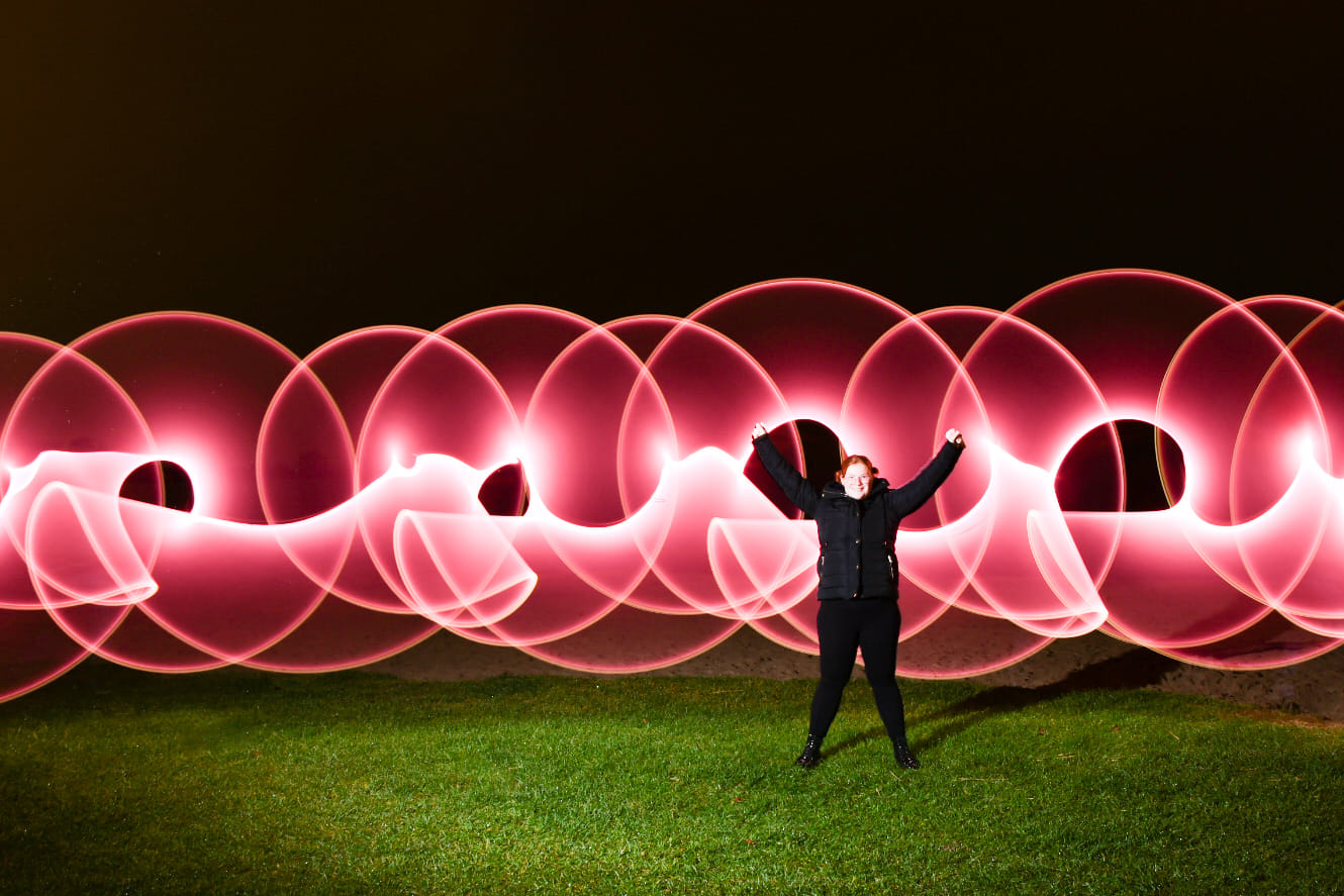 pink graffiti wall behind model with light drawing