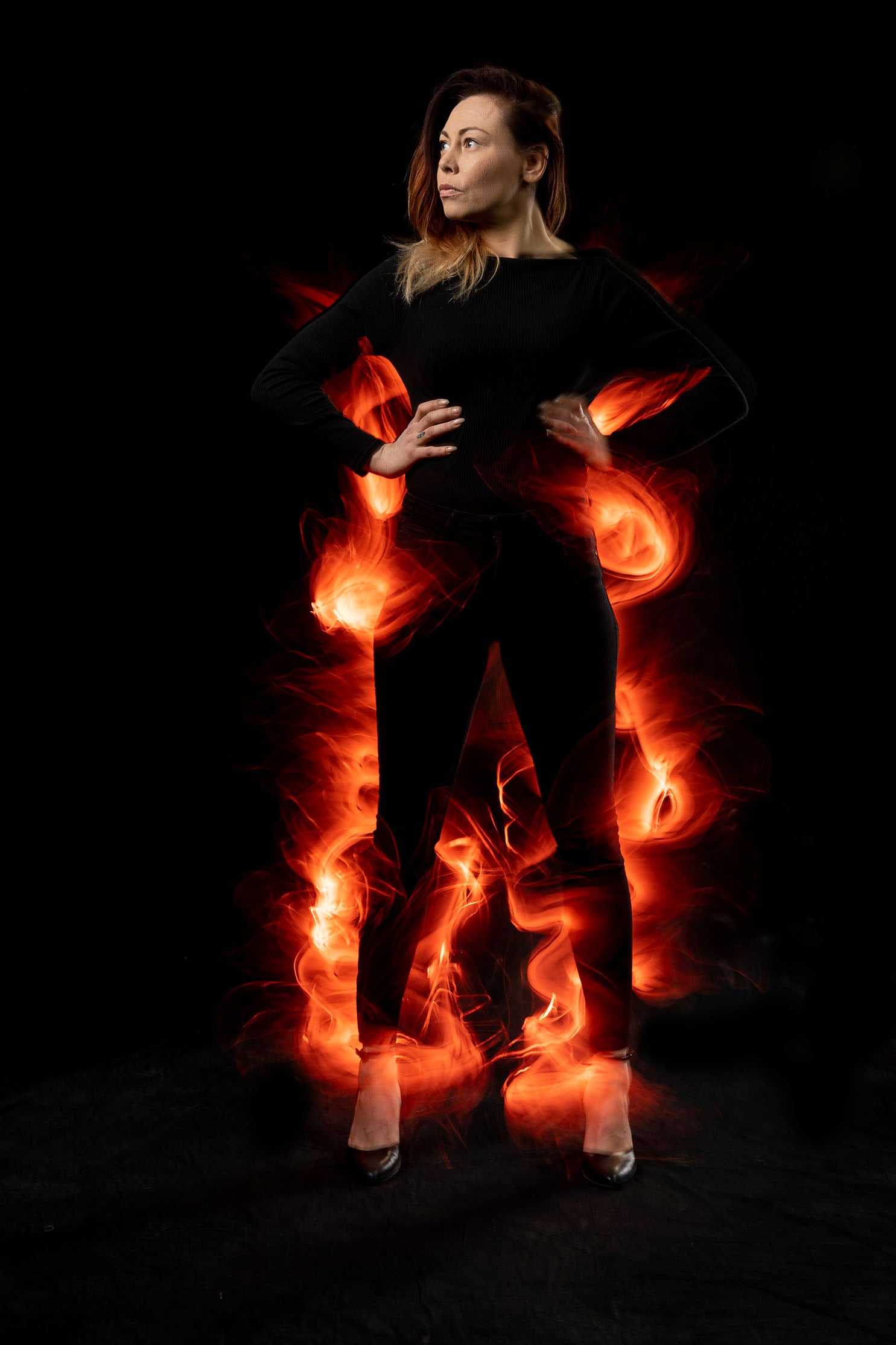 Model on fire with flames from light painting blade