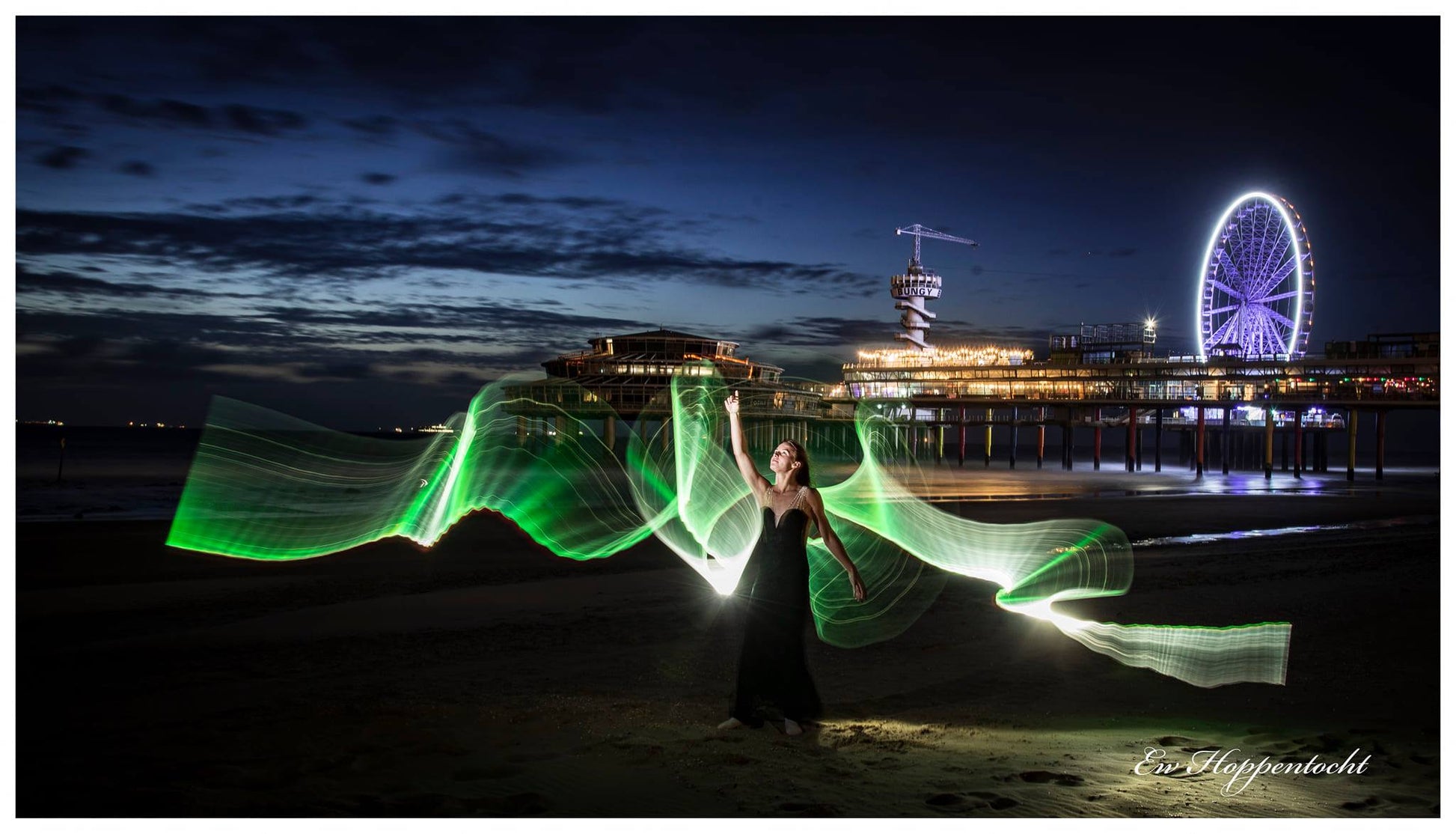Light painting tube green northern light at the beach with long exposure